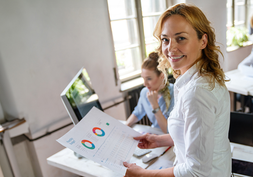 Smiling woman with document in her hand